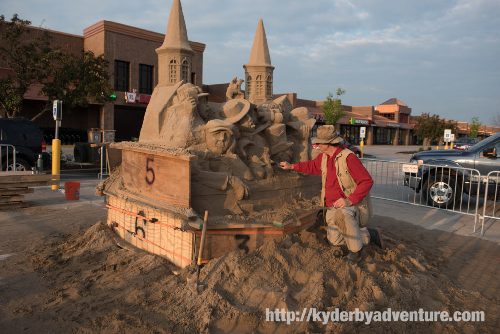 Sand sculpture artist Damon works on a Kentucky Derby themed sculpture in the parking lot of Kroger where the Garland of Lilies and Garland of Roses are made for the Kentucky Oaks and Derby.
