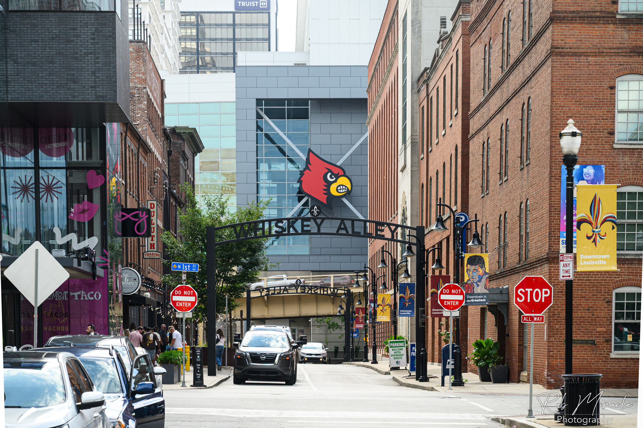 A view down Louisville's Washington Street, also know as Whiskey Alley. The Yum Brands Arena with the University of Louisville Cardinal Logo can be seen at the end.